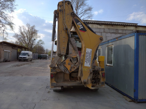 Caterpillar 428F2 с гидромолотом CAT H70d